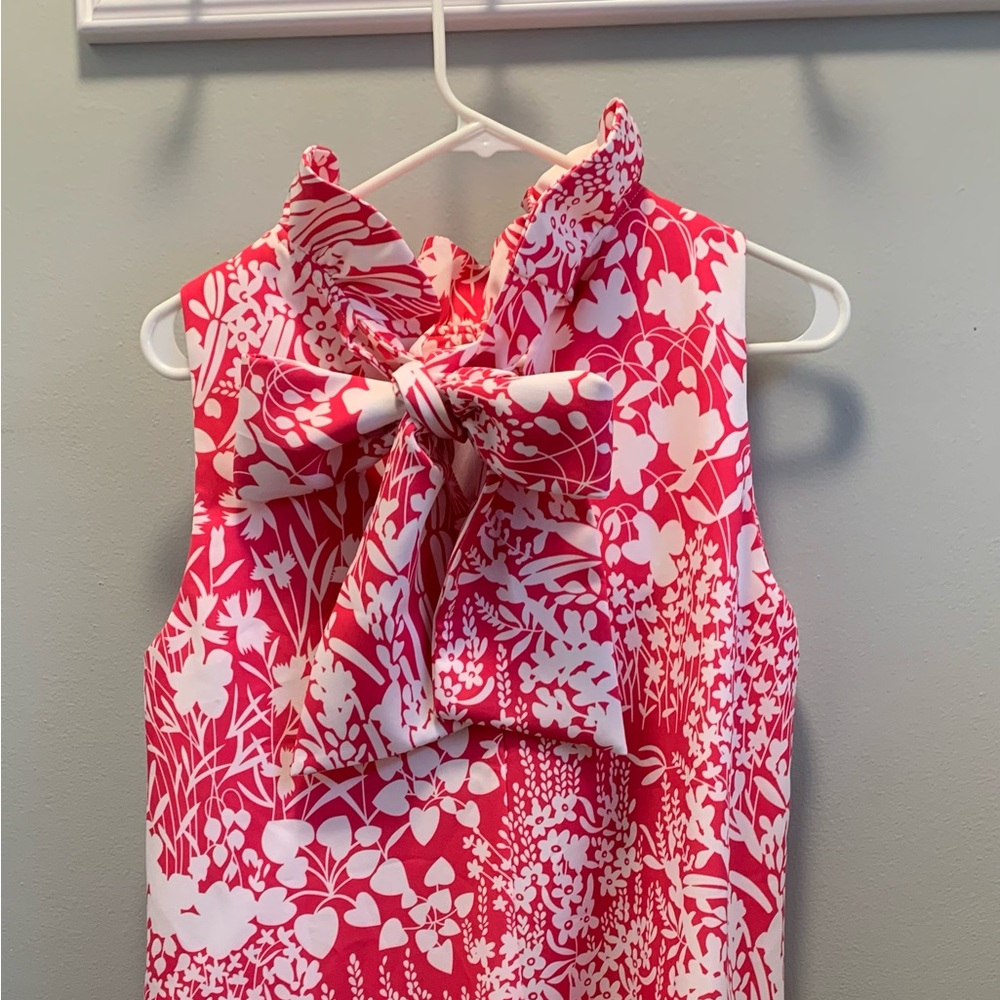 Super comfortable,and flattering Quality fabric, ruffled neck, with bow on back.